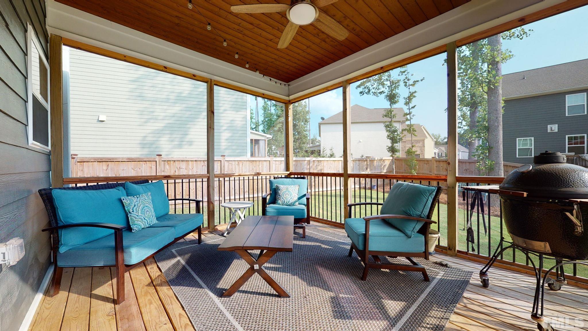 2351 Terrmini Drive Apex, NC 27502 - Photo 26 of 30 a living room with furniture and a floor to ceiling window