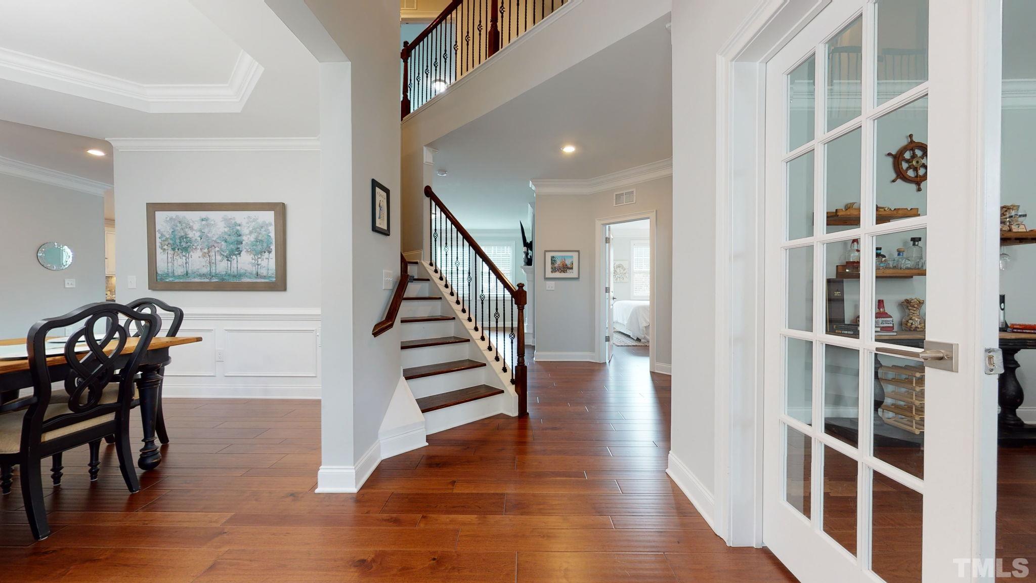 2351 Terrmini Drive Apex, NC 27502 - Photo 3 of 30 a view of a hallway with wooden floor and staircase