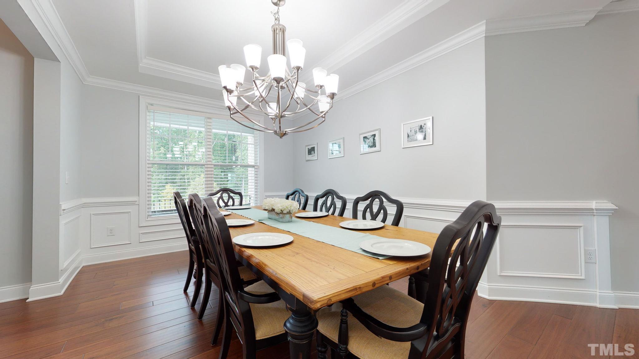 2351 Terrmini Drive Apex, NC 27502 - Photo 5 of 30 a view of a dining room with furniture a chandelier and wooden floor