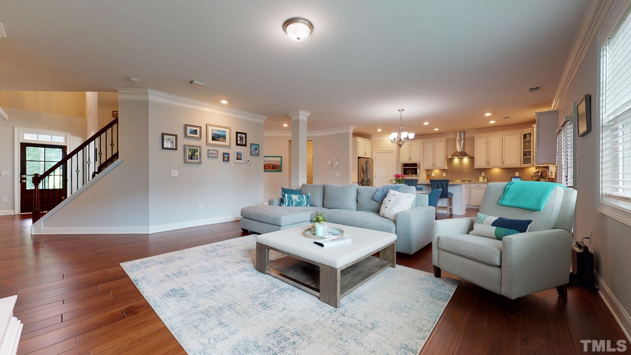2351 Terrmini Drive Apex, NC 27502 - Photo 6 of 30 a living room with furniture and wooden floor