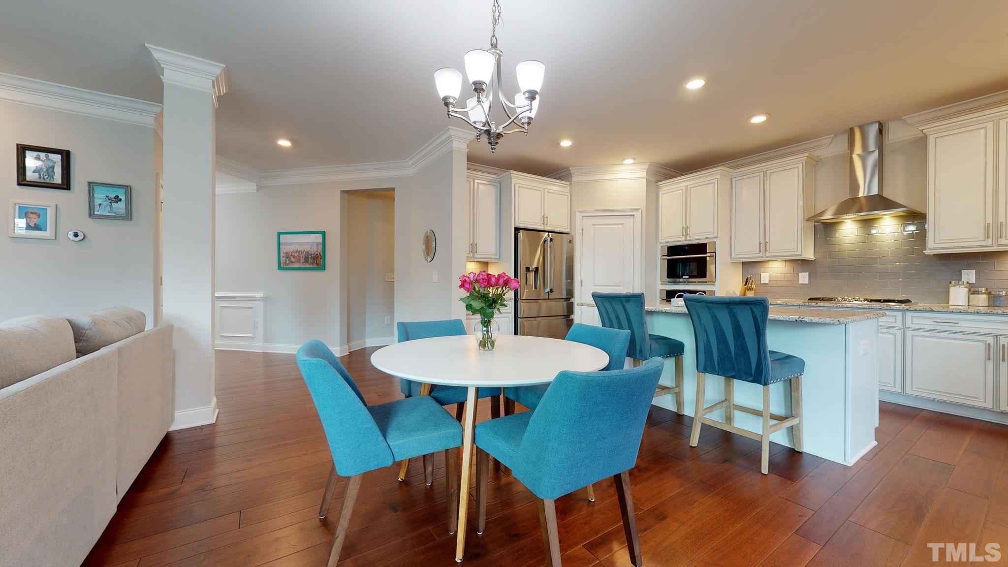 2351 Terrmini Drive Apex, NC 27502 - Photo 7 of 30 a view of a dining room with furniture and wooden floor