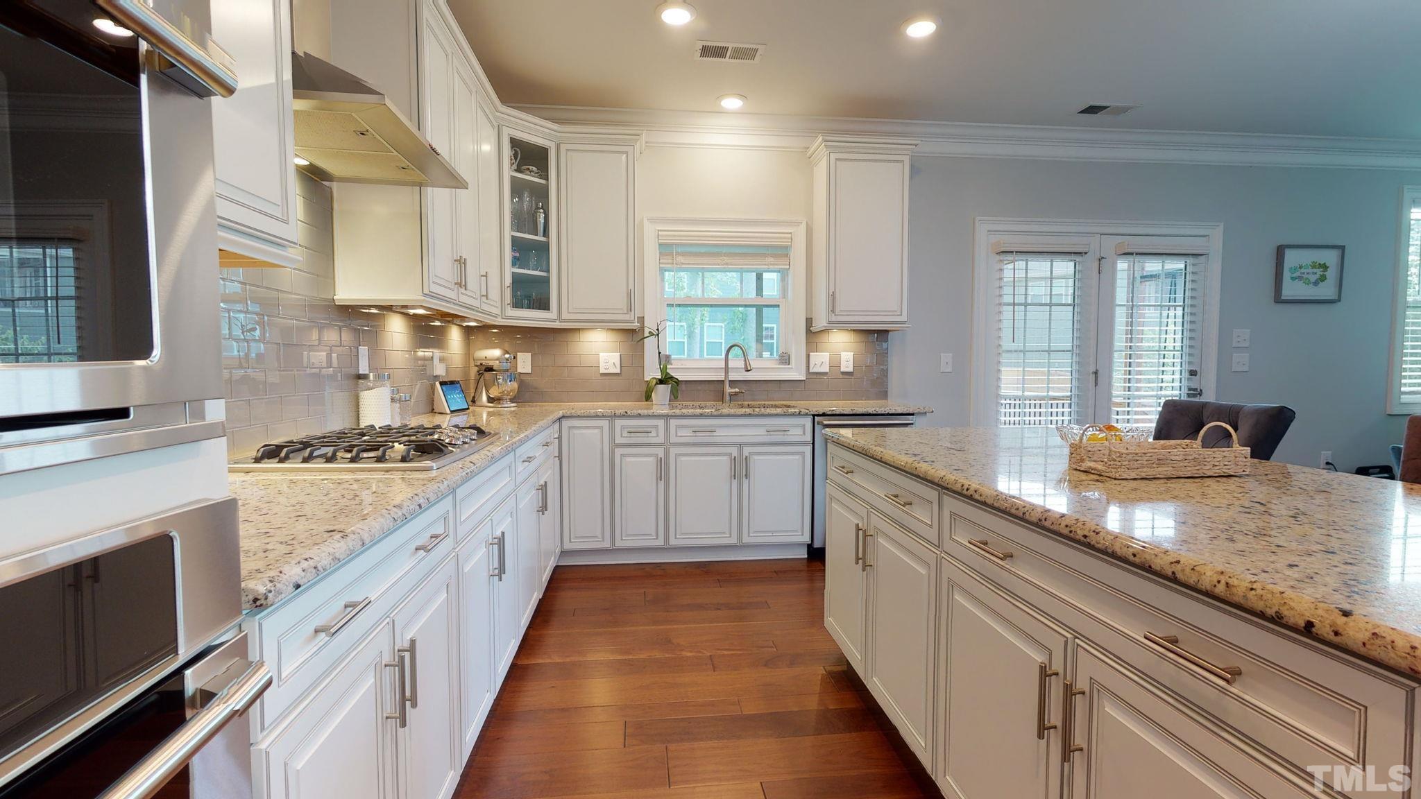 2351 Terrmini Drive Apex, NC 27502 - Photo 8 of 30 a large kitchen with stainless steel appliances granite countertop a lot of counter space and a sink