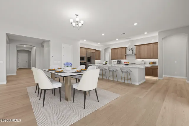 a kitchen with stainless steel appliances granite countertop a sink and a refrigerator
