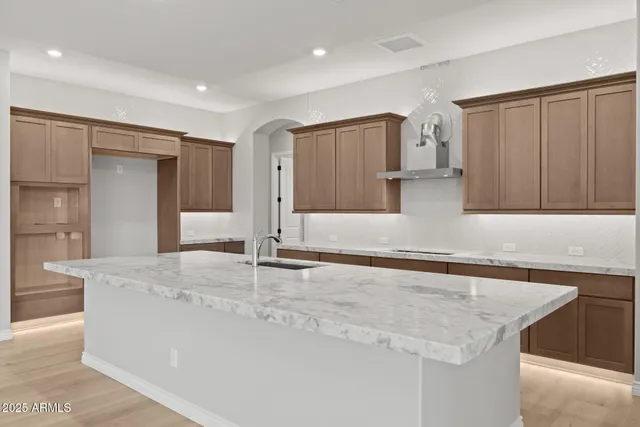 a view of a kitchen with a sink and a large mirror