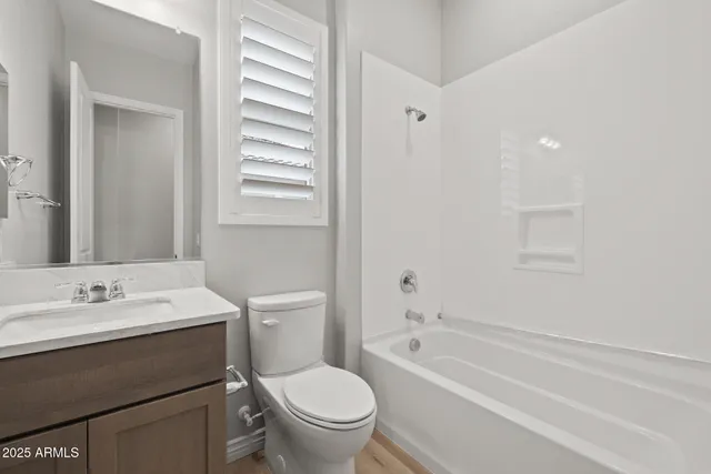 an aerial view of a house with a garden and lake view