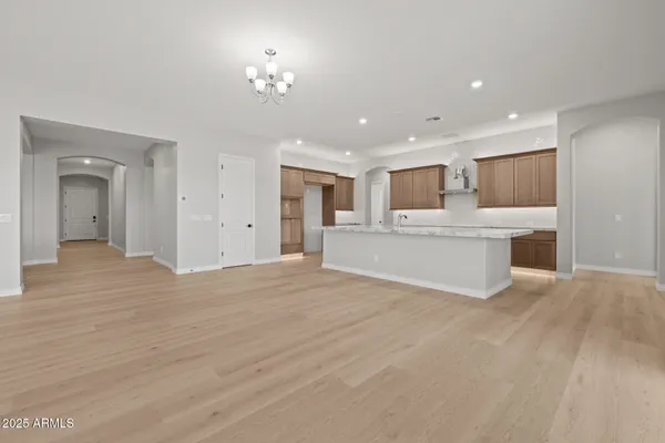 a large kitchen with stainless steel appliances granite countertop a large counter top and a stove