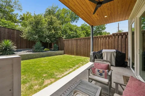a view of a backyard with a patio and outdoor seating