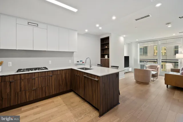 a kitchen with granite countertop a sink and a stove top oven