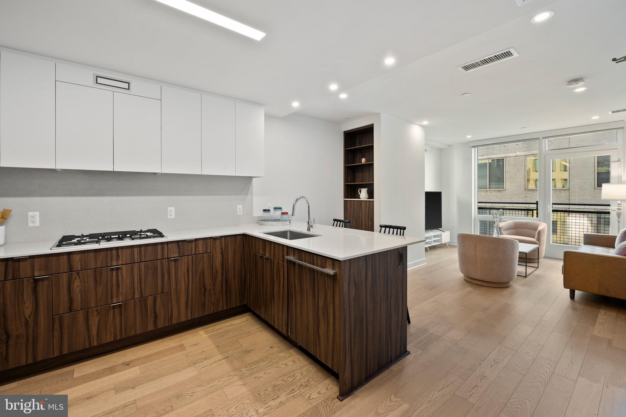 a kitchen with granite countertop a sink and a stove top oven