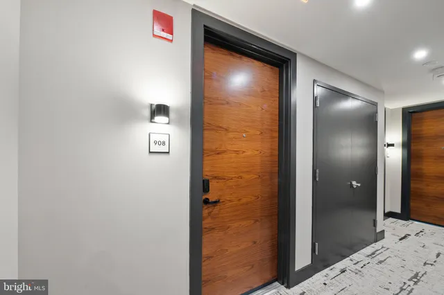 a living room with furniture a flat screen tv and kitchen view
