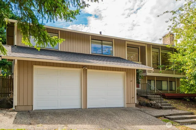a view of a house with a door and wooden walls