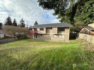 529 Southwest 324th Street Federal Way, WA 98023 - Photo 2 of 22 a backyard of a house with table and chairs