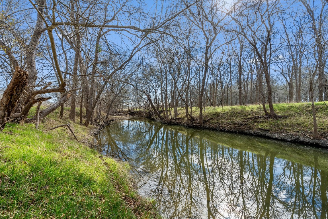 a lake view with wooden fence