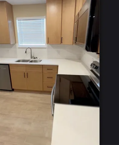 a kitchen with a sink and a stove