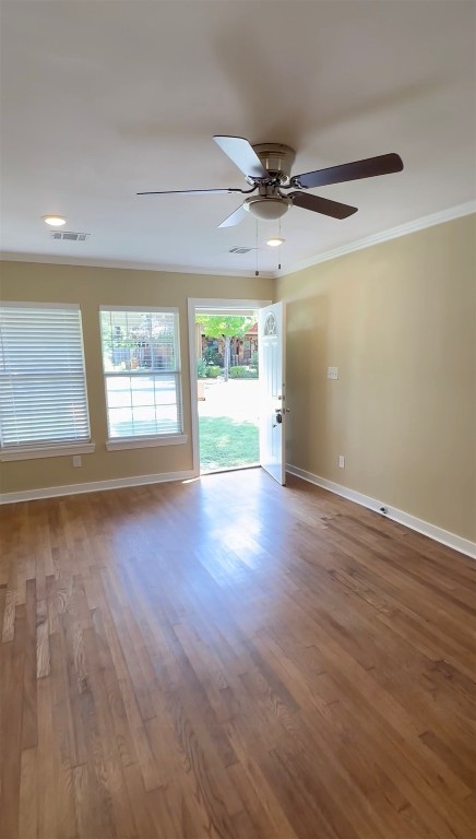 713 Harris Avenue Austin, TX 78705 - Photo 4 of 12 an empty room with wooden floor and windows