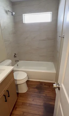 a bathroom with a toilet a sink and bathtub