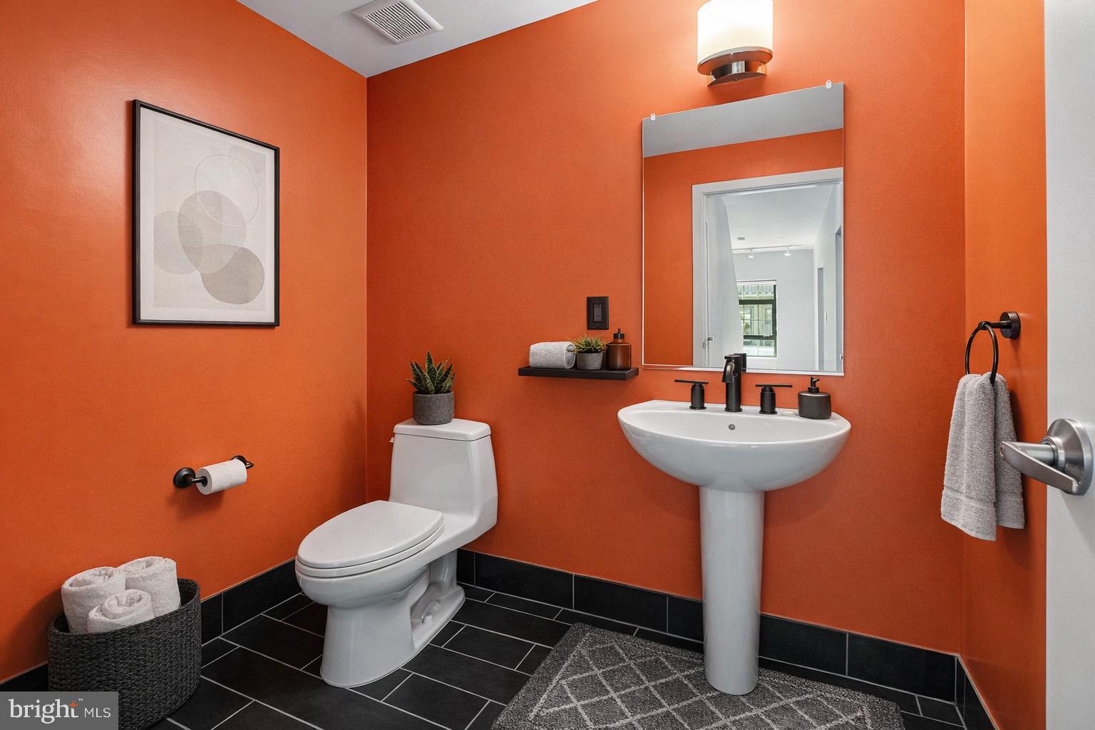 1200 Steuart Street, Unit 1035 Baltimore, MD 21230 - Photo 26 of 96 a bathroom with a toilet sink and mirror