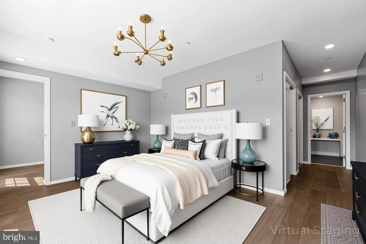 1200 Steuart Street, Unit 1035 Baltimore, MD 21230 - Photo 35 of 96 a bedroom with bed and a chandelier