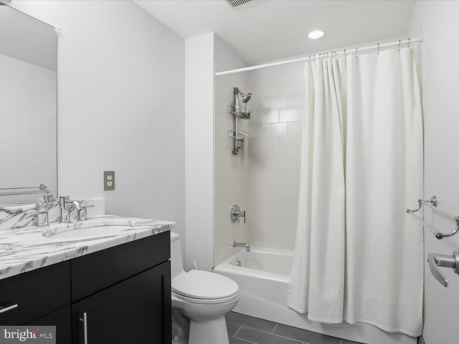 1200 Steuart Street, Unit 1035 Baltimore, MD 21230 - Photo 39 of 96 a bathroom with a sink a toilet and shower