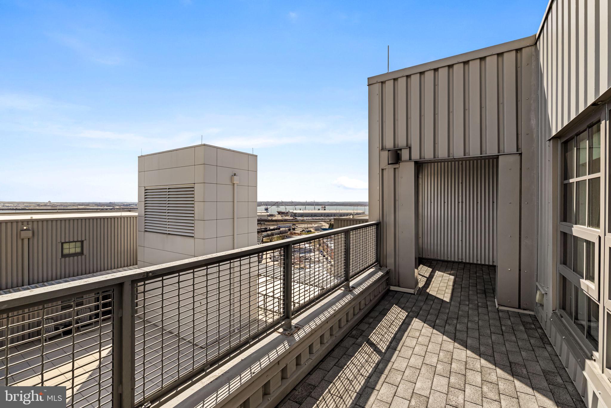 1200 Steuart Street, Unit 1035 Baltimore, MD 21230 - Photo 46 of 96 a view of a balcony with wooden floor and fence