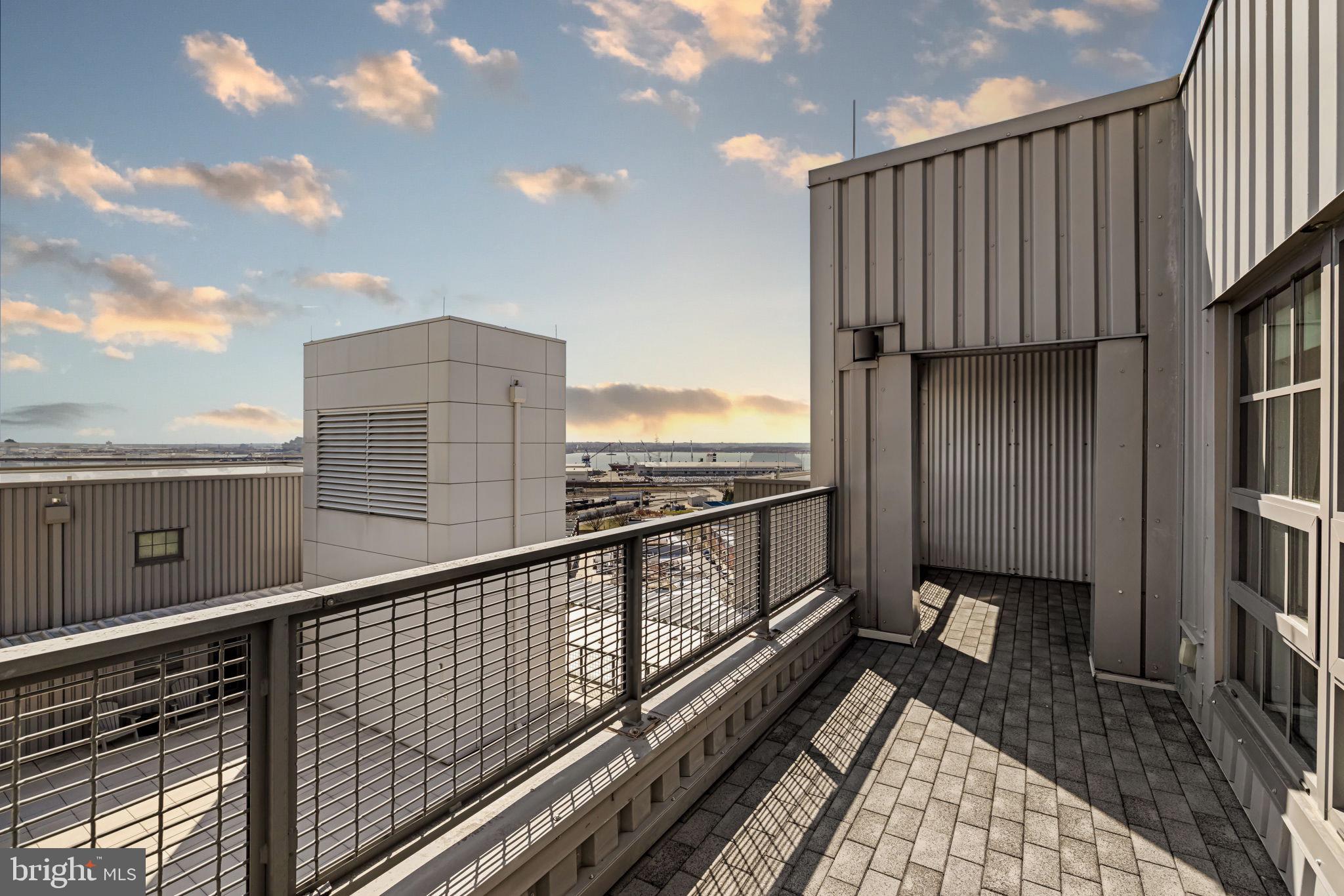 1200 Steuart Street, Unit 1035 Baltimore, MD 21230 - Photo 47 of 96 a view of a balcony with wooden floor and fence