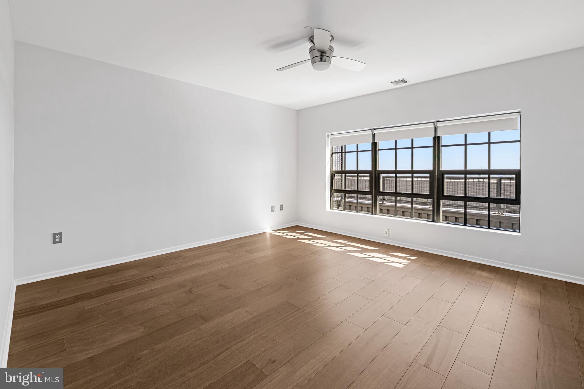 1200 Steuart Street, Unit 1035 Baltimore, MD 21230 - Photo 54 of 96 wooden floor in an empty room with a window