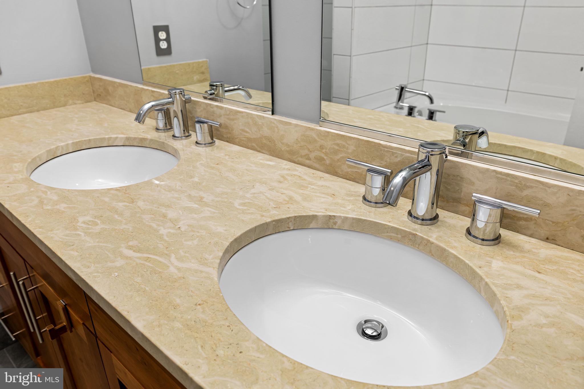 1200 Steuart Street, Unit 1035 Baltimore, MD 21230 - Photo 57 of 96 a bathroom with a granite countertop sink and a mirror