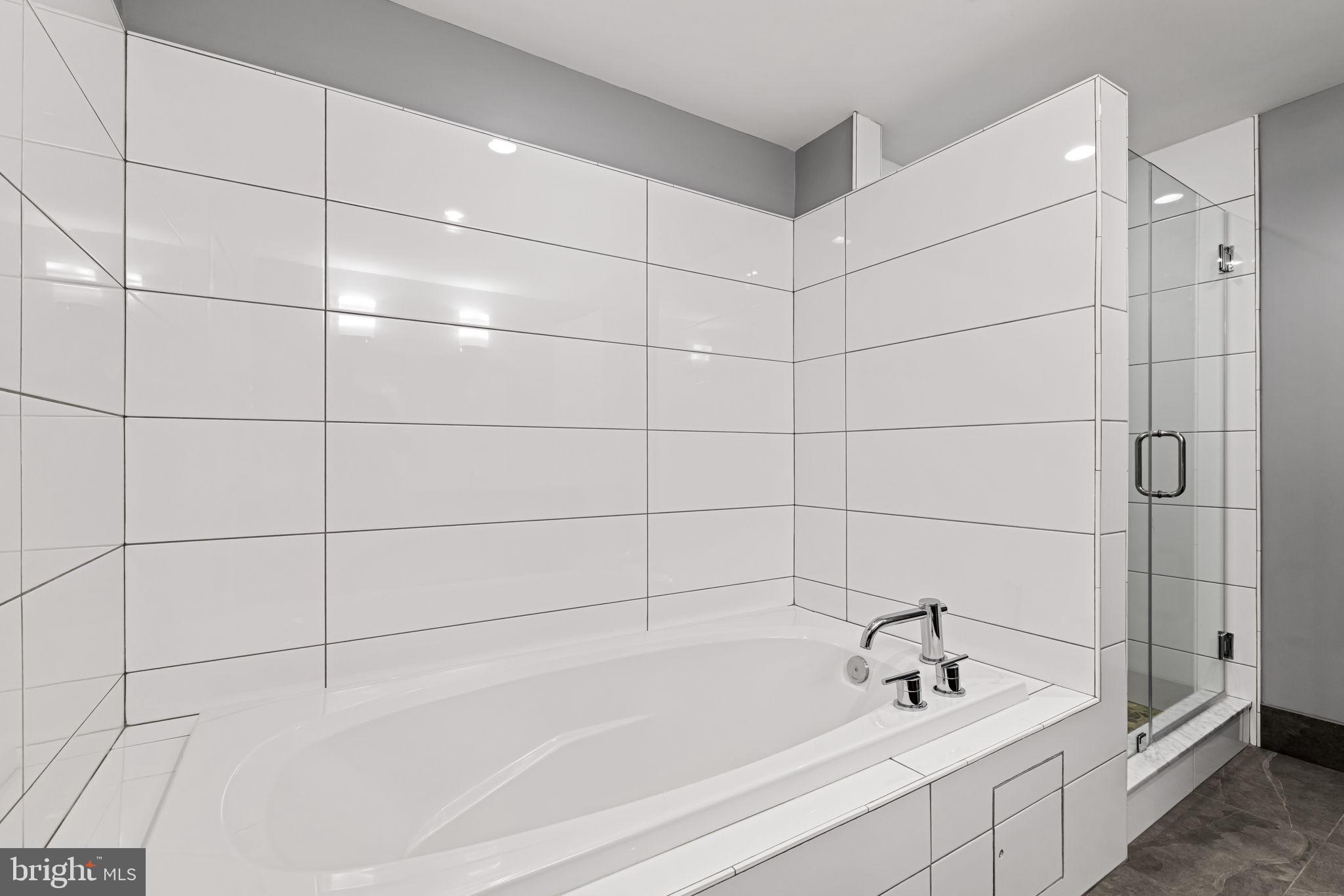 1200 Steuart Street, Unit 1035 Baltimore, MD 21230 - Photo 58 of 96 a bathroom with a bathtub and shower