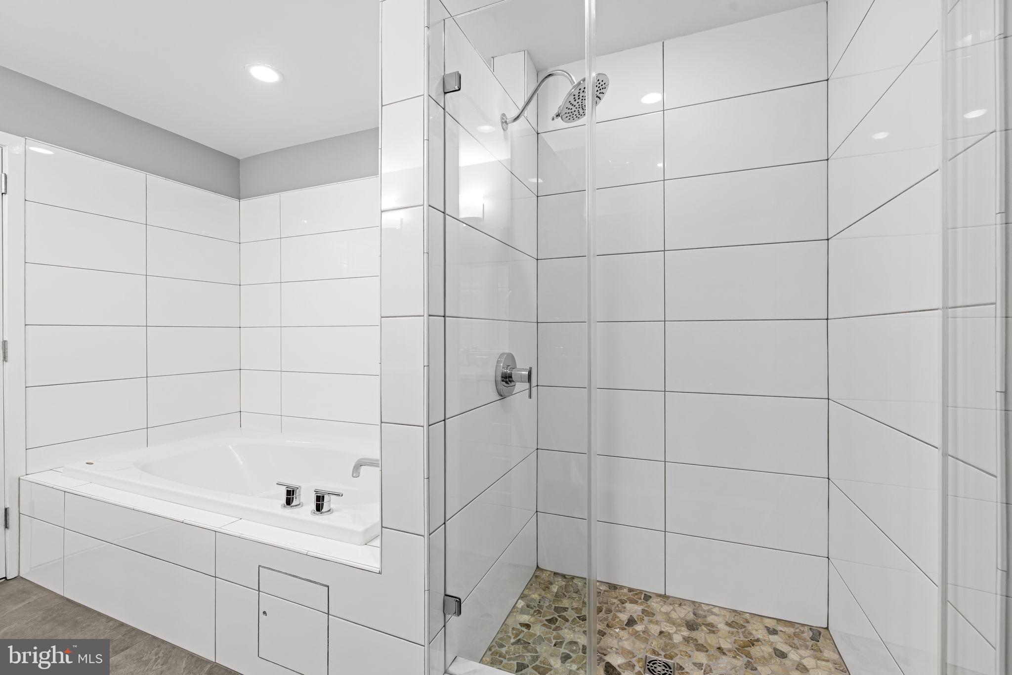 1200 Steuart Street, Unit 1035 Baltimore, MD 21230 - Photo 60 of 96 a bathroom with a bathtub and shower