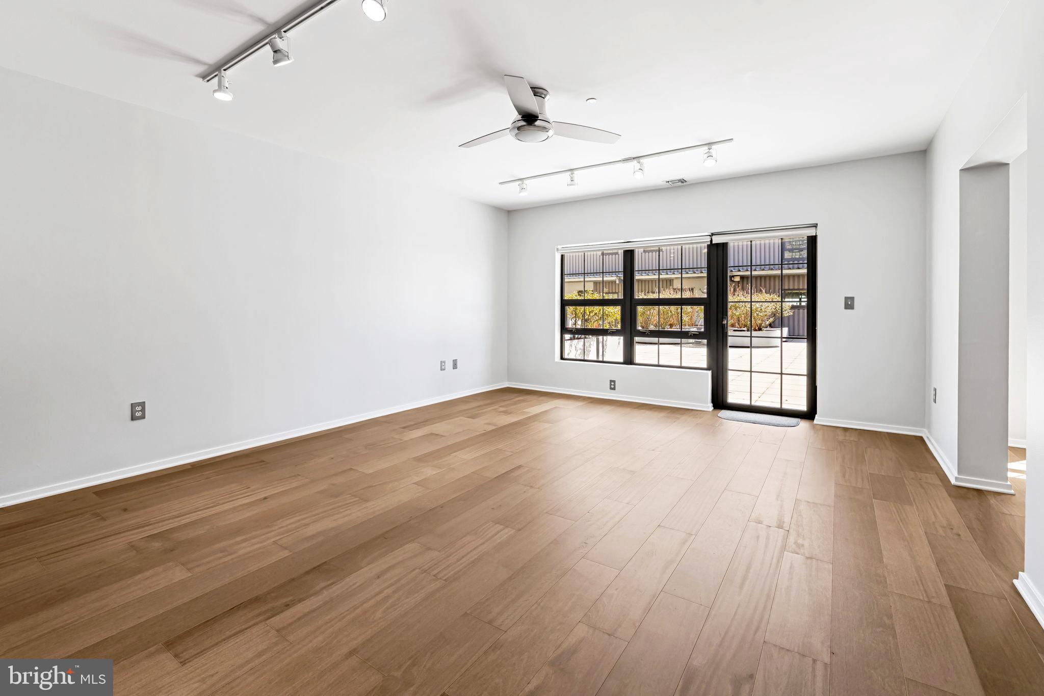 1200 Steuart Street, Unit 1035 Baltimore, MD 21230 - Photo 7 of 96 wooden floor in an empty room with a window