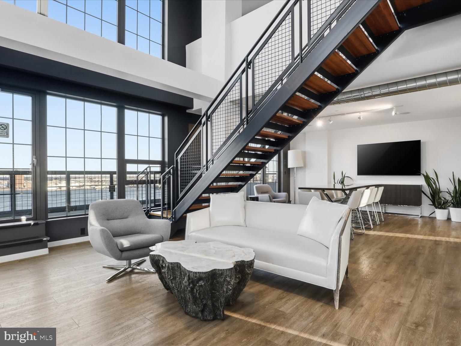 1200 Steuart Street, Unit 1035 Baltimore, MD 21230 - Photo 90 of 96 a living room with furniture and a flat screen tv