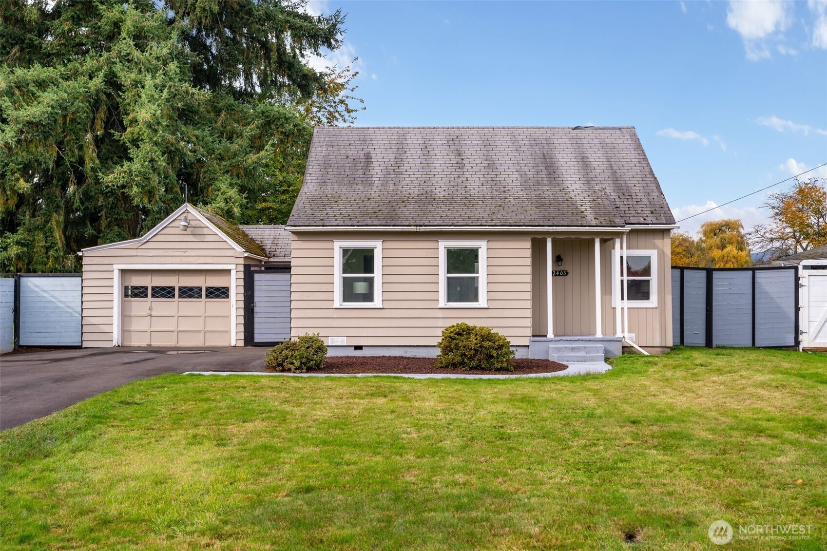 2403 34th Avenue Longview, WA 98632 - Photo 2 of 40 a front view of a house with a yard and garage