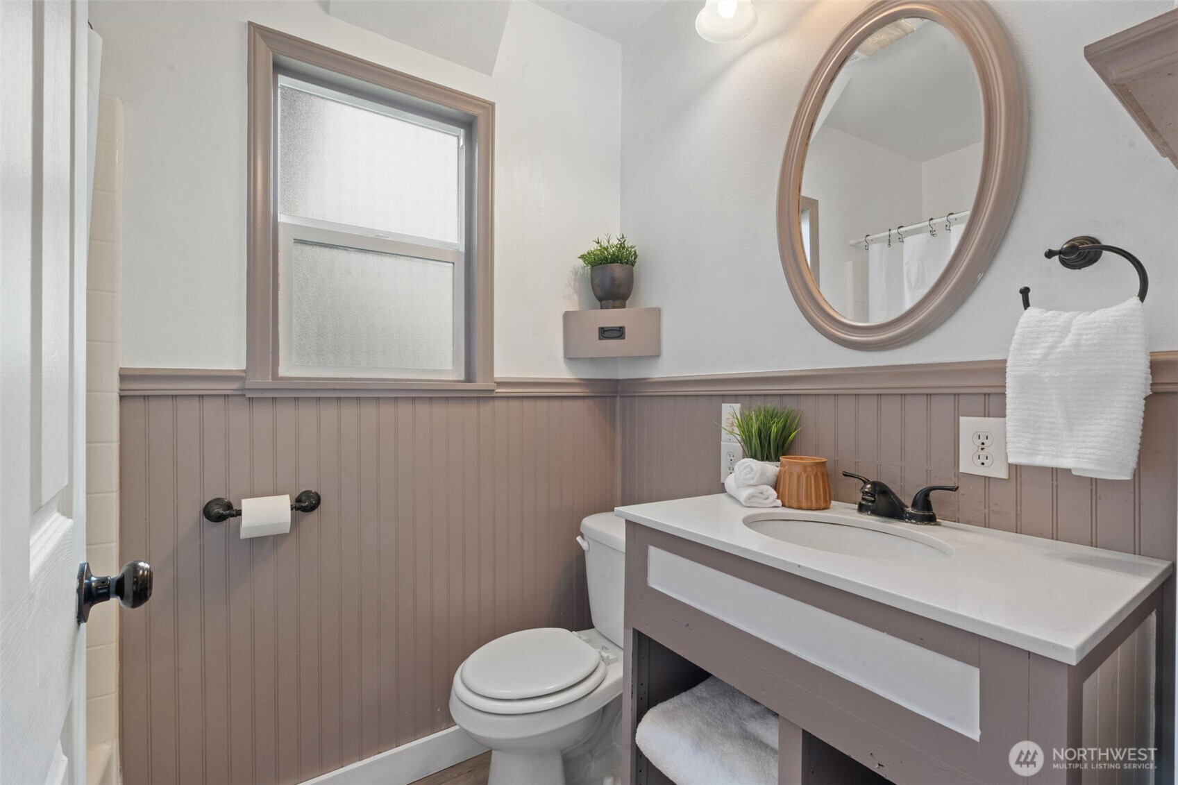 2403 34th Avenue Longview, WA 98632 - Photo 23 of 40 a bathroom with a toilet a sink and a mirror