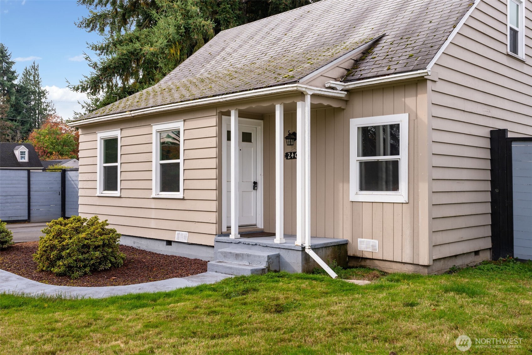 2403 34th Avenue Longview, WA 98632 - Photo 3 of 40 a house that has a big yard plants and large trees with wooden fence