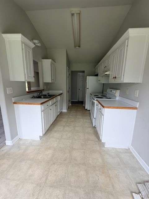 506 Cherokee Road Winder, GA 30680 - Photo 6 of 11 a kitchen with stainless steel appliances a sink a stove a microwave a sink a refrigerator and cabinets