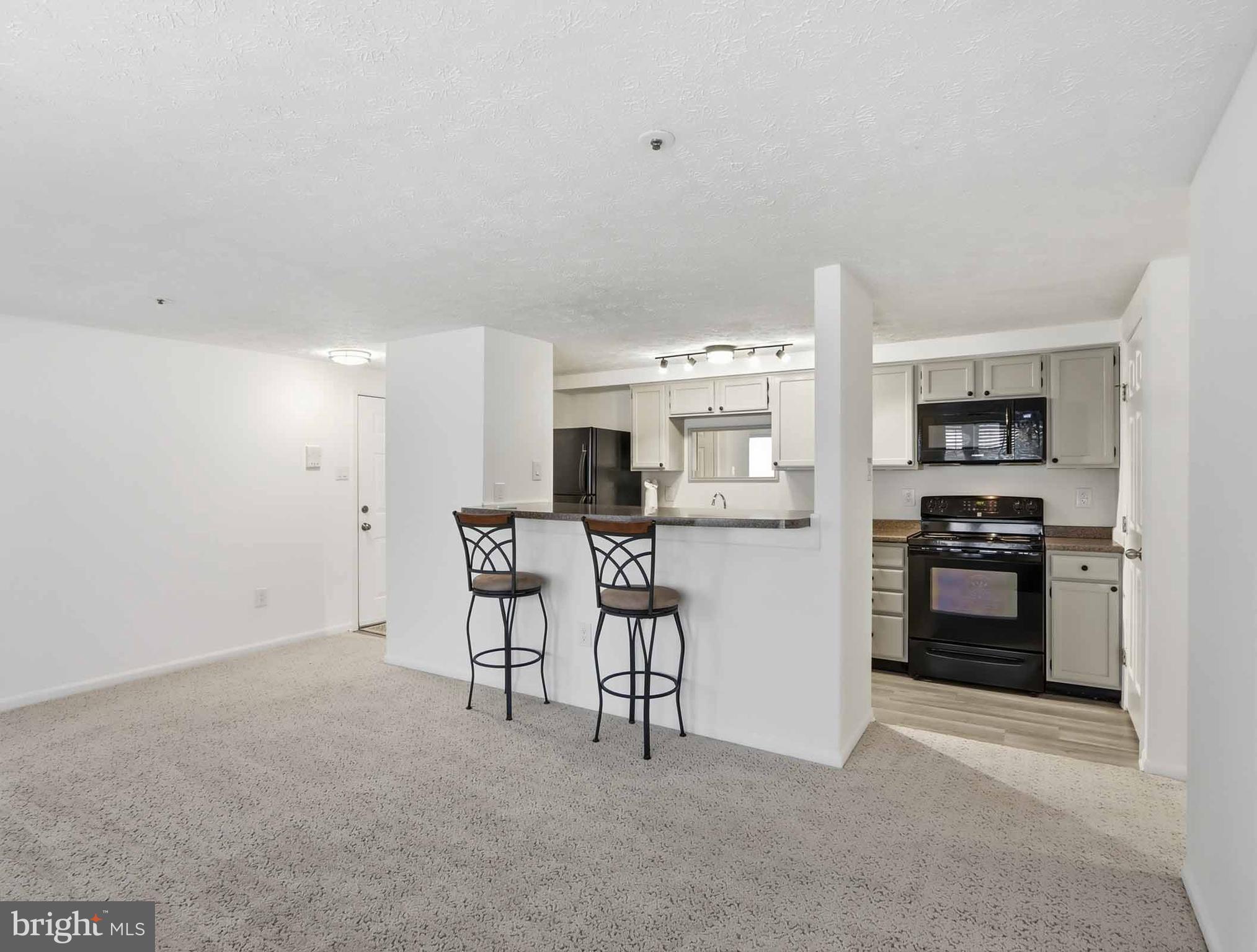 697 Deering Road, Unit 5A Pasadena, MD 21122 - Photo 11 of 24 a kitchen with a refrigerator and a stove top oven