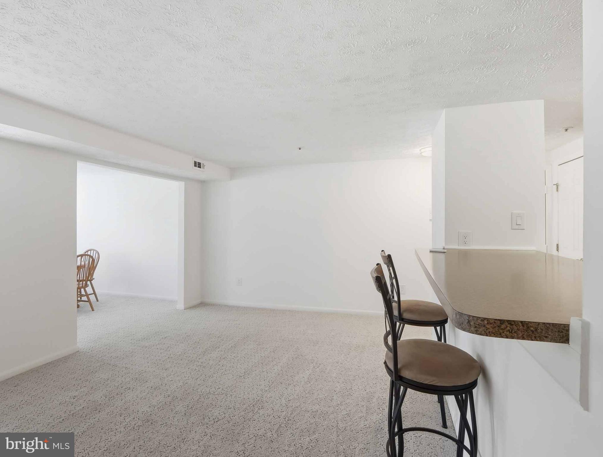 697 Deering Road, Unit 5A Pasadena, MD 21122 - Photo 12 of 24 a view of a room with chairs and a table