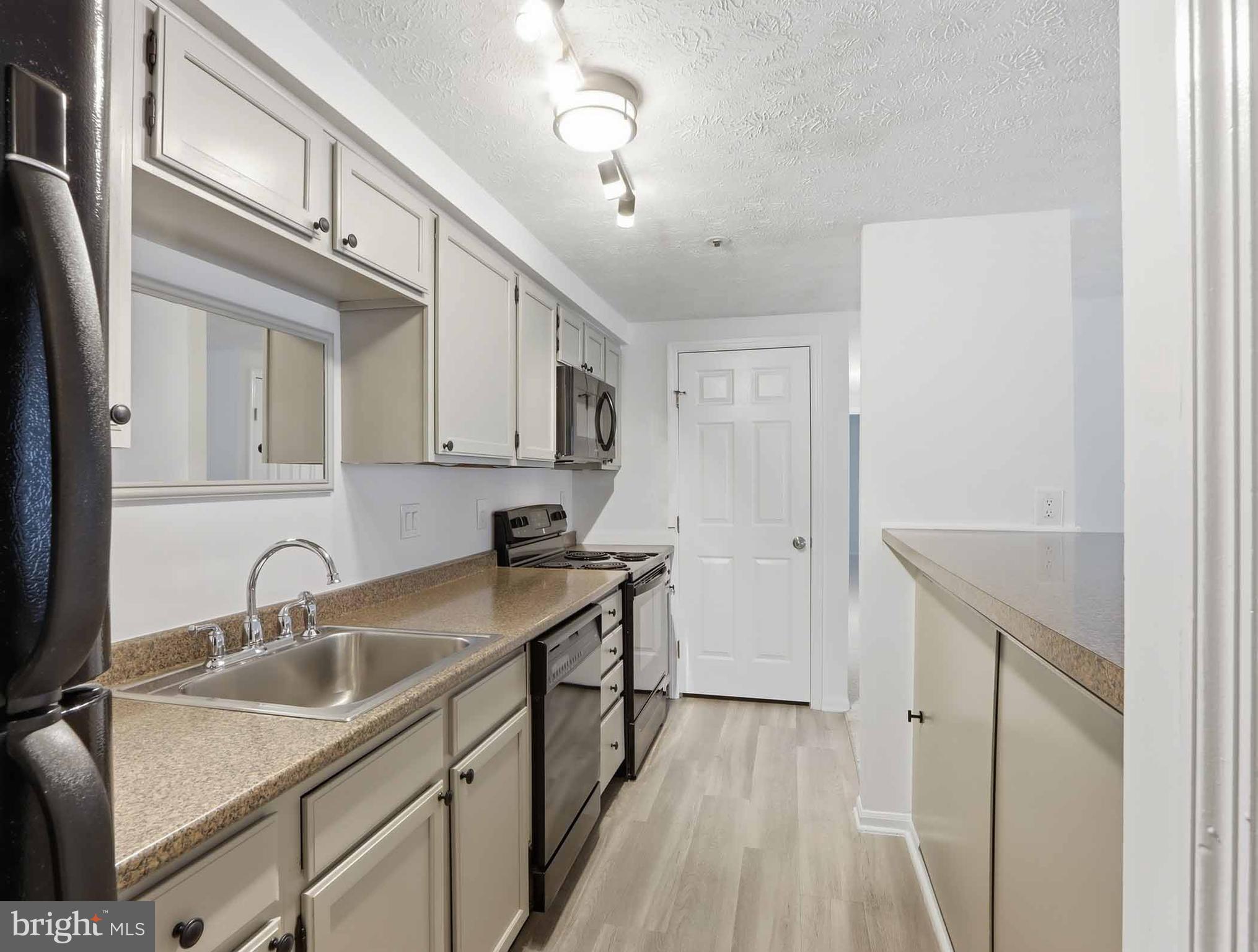697 Deering Road, Unit 5A Pasadena, MD 21122 - Photo 14 of 24 a kitchen with a sink and cabinets