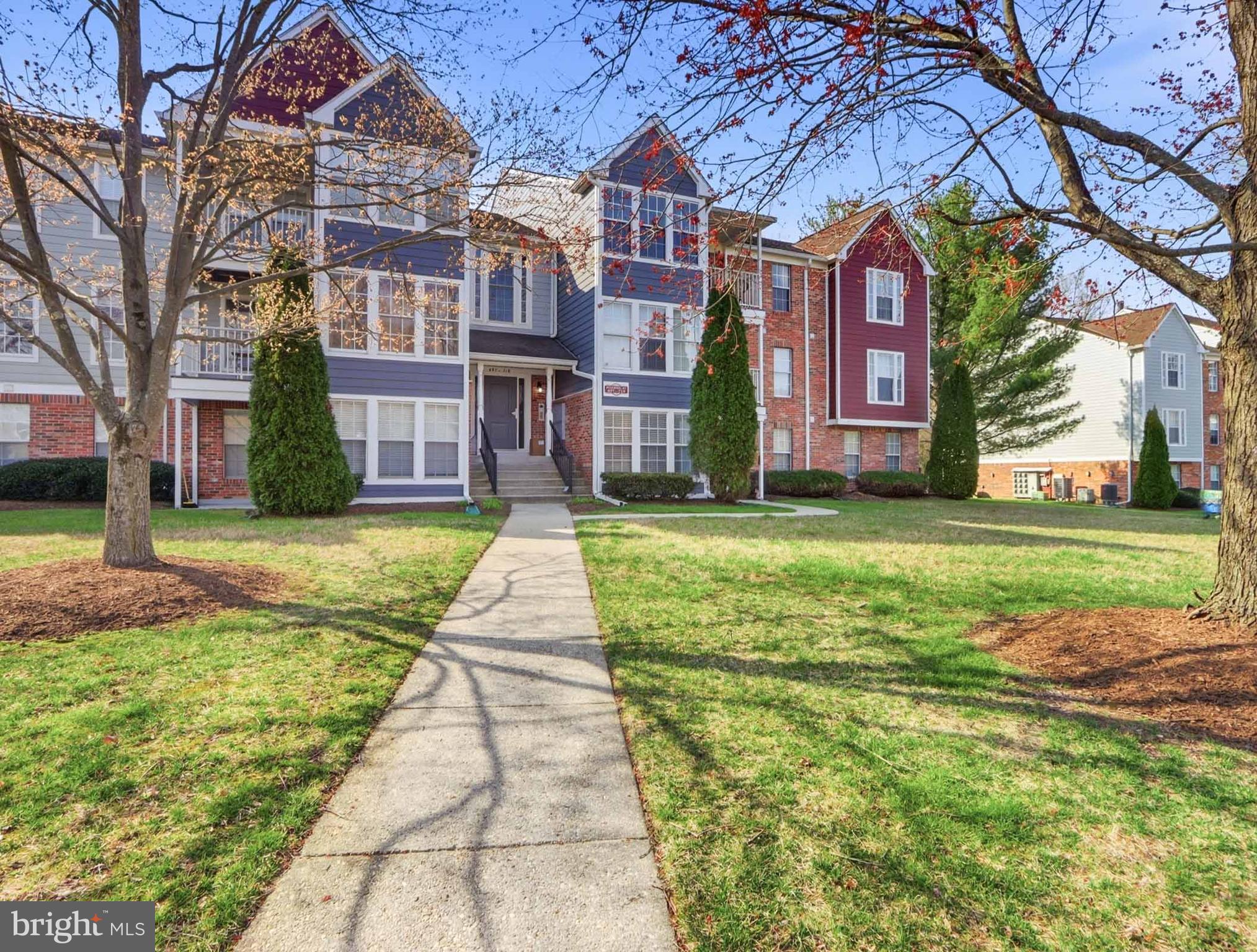 697 Deering Road, Unit 5A Pasadena, MD 21122 - Photo 2 of 24 a view of a big building with a big yard and large trees