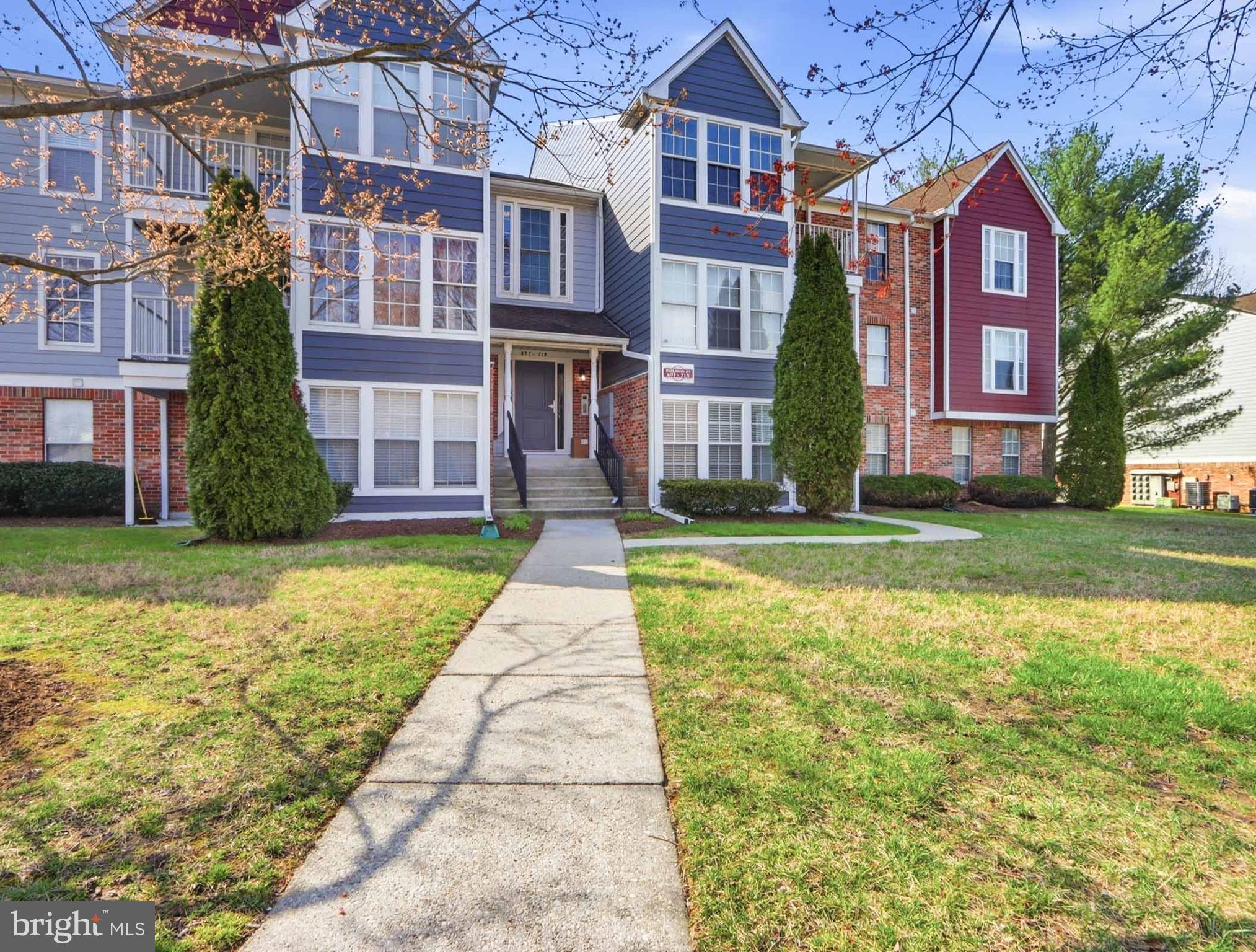 697 Deering Road, Unit 5A Pasadena, MD 21122 - Photo 4 of 24 front view of a brick house with a yard