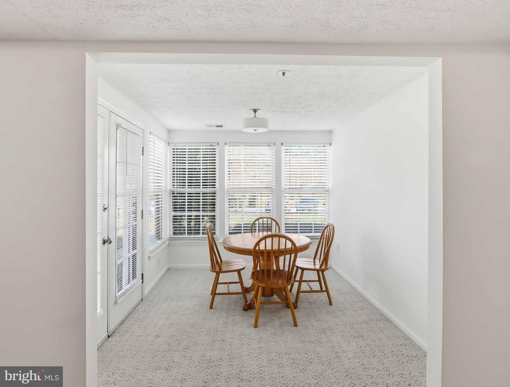697 Deering Road, Unit 5A Pasadena, MD 21122 - Photo 9 of 24 a view of a dining room with furniture window and outside view
