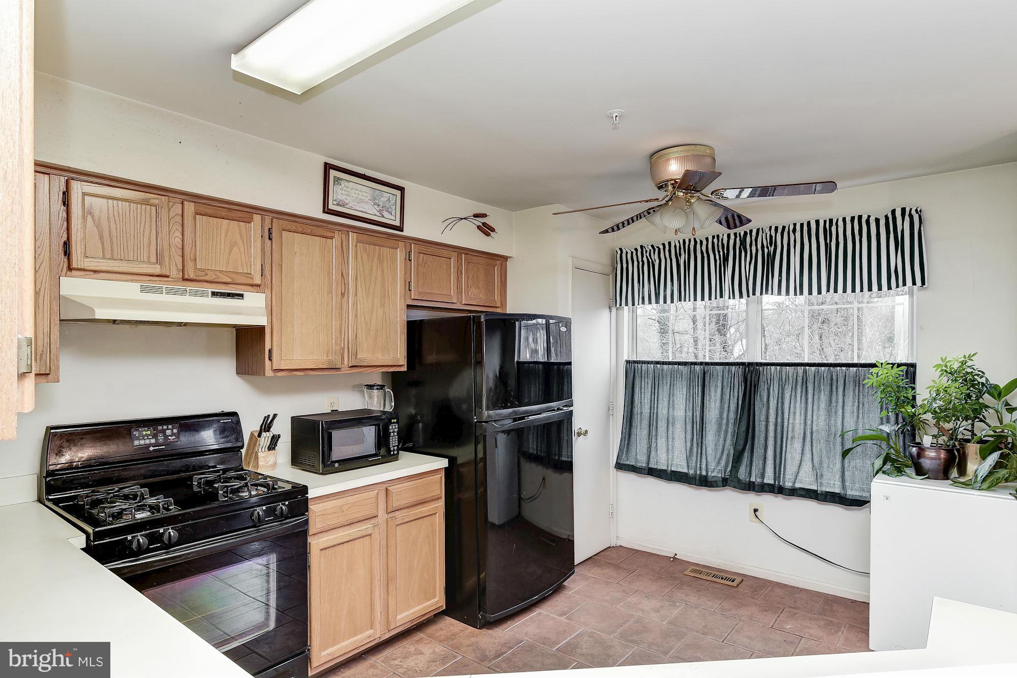 804 Alabaster Court Capitol Heights, MD 20743 - Photo 11 of 30 a kitchen with a sink a stove and cabinets