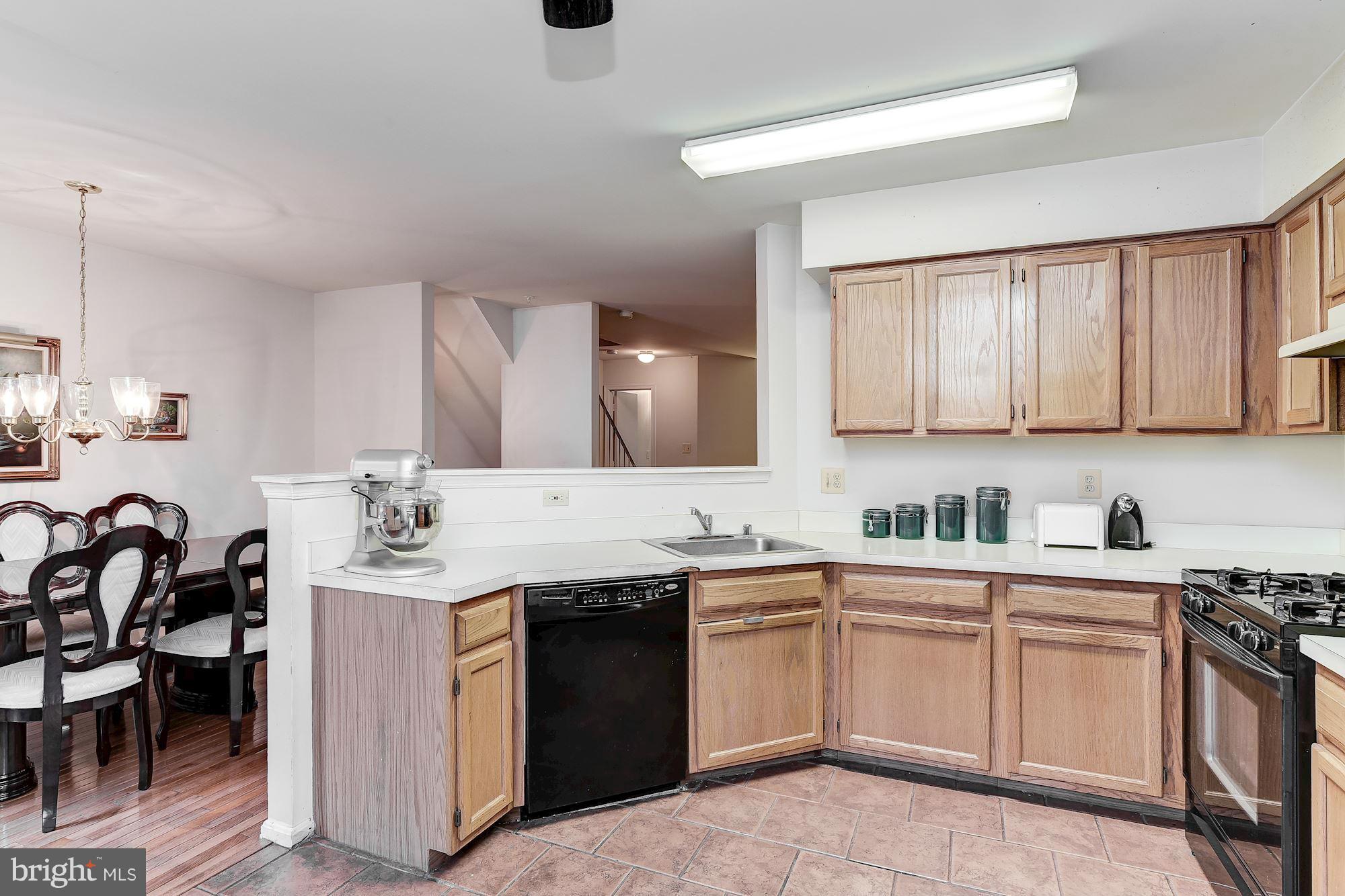804 Alabaster Court Capitol Heights, MD 20743 - Photo 13 of 30 a kitchen with a sink stove and cabinets