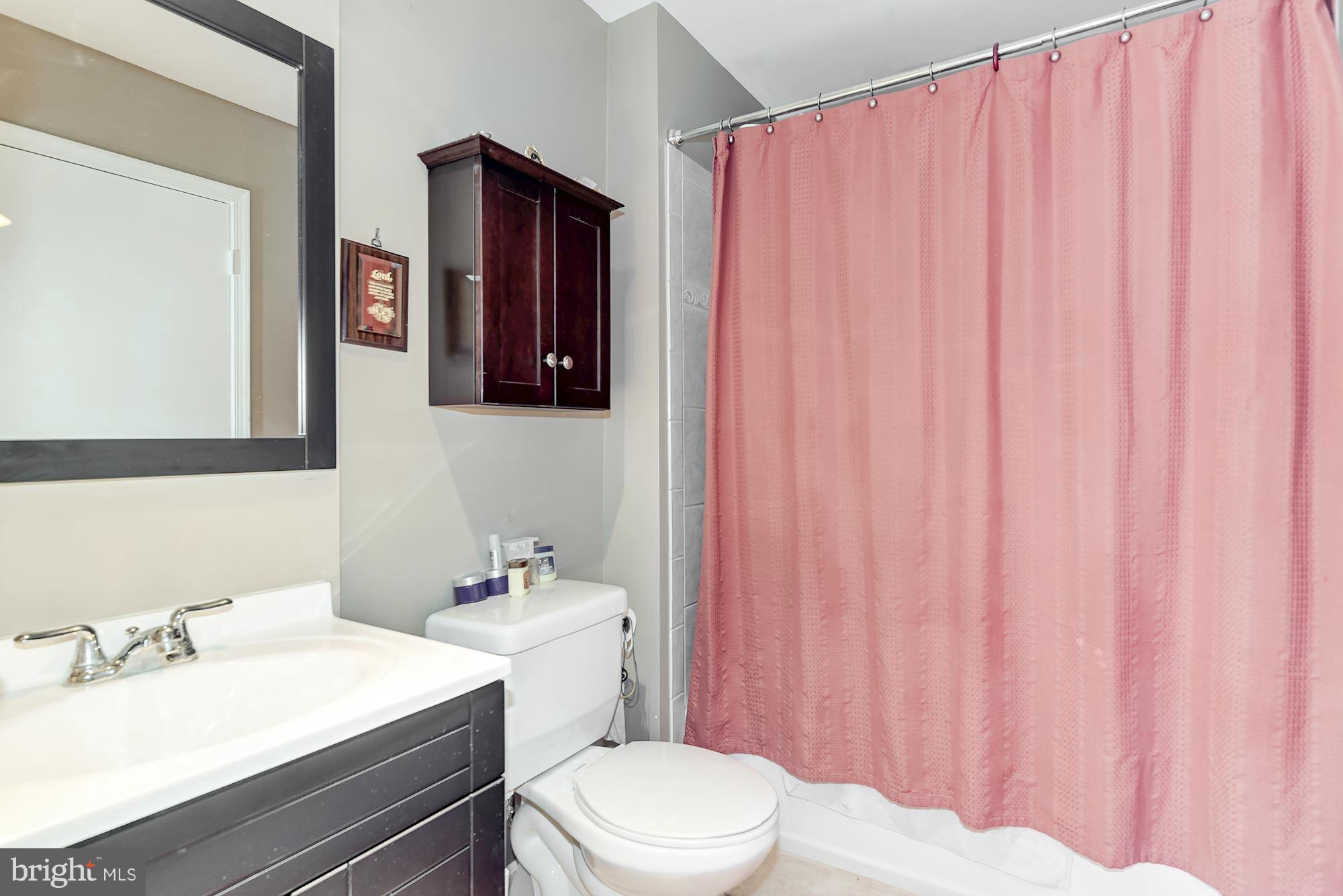 804 Alabaster Court Capitol Heights, MD 20743 - Photo 25 of 30 a bathroom with a sink a toilet and shower curtain