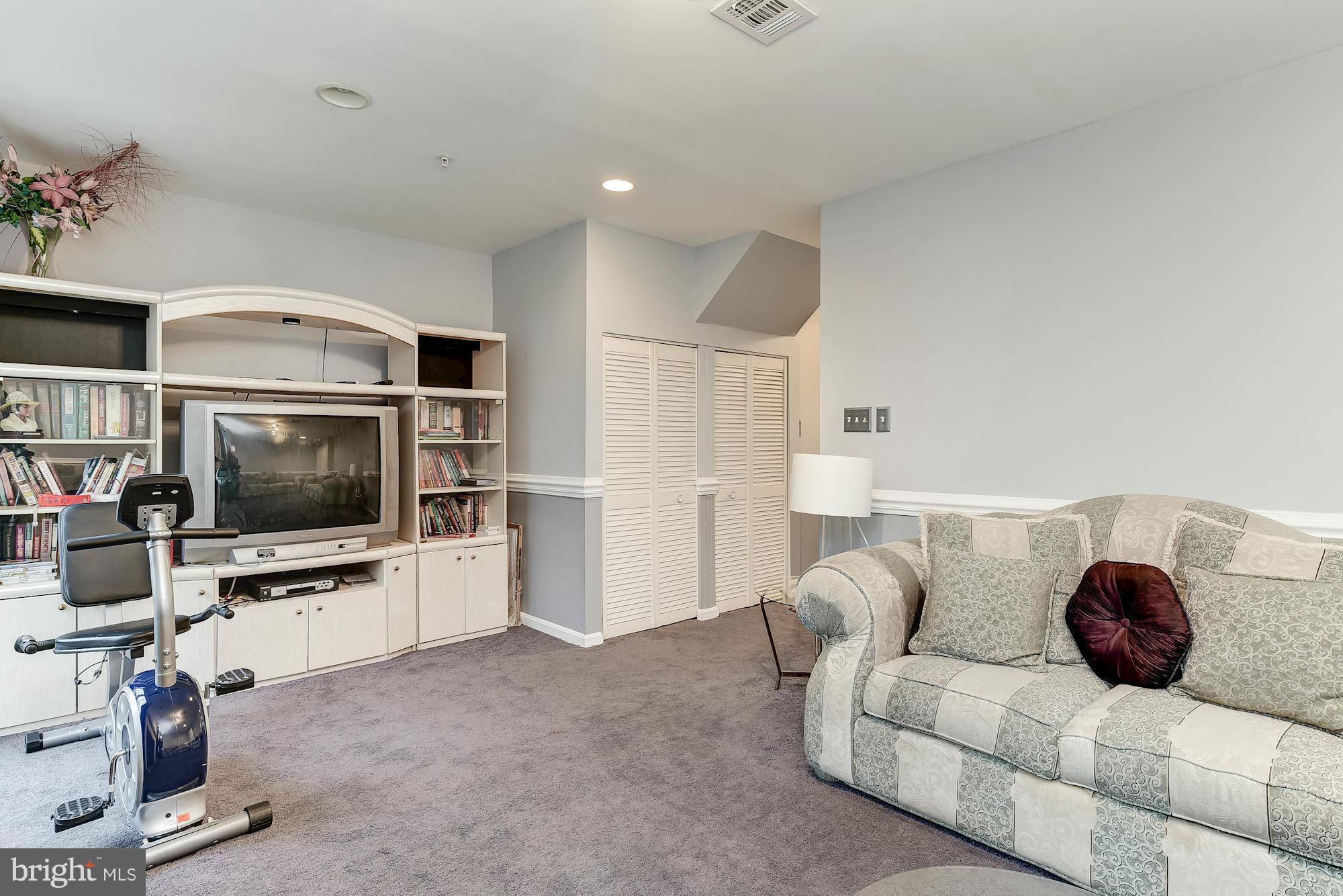 804 Alabaster Court Capitol Heights, MD 20743 - Photo 27 of 30 a living room with furniture and a flat screen tv