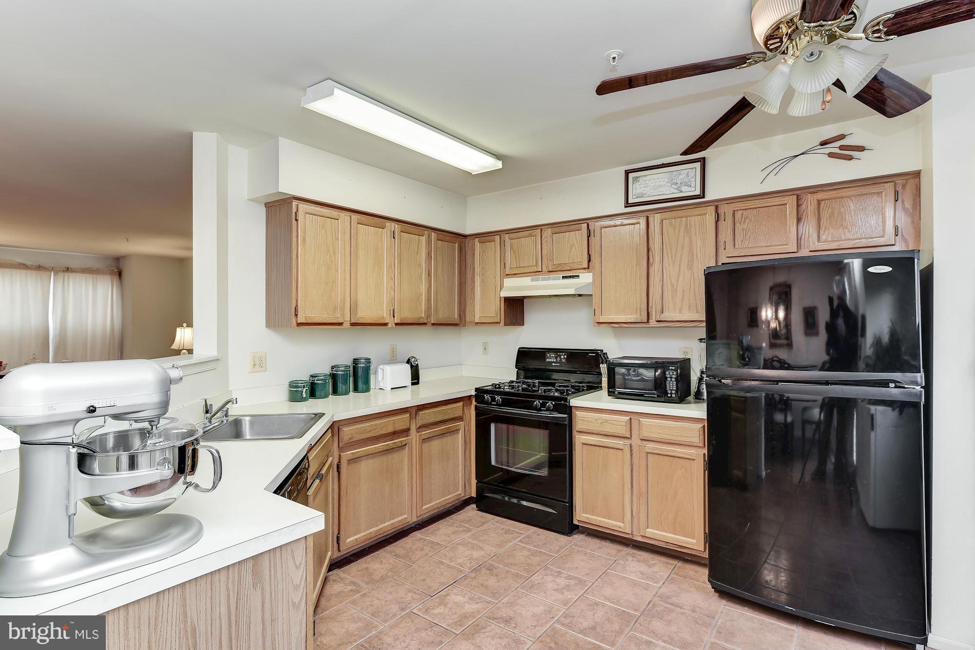 804 Alabaster Court Capitol Heights, MD 20743 - Photo 10 of 30 a kitchen with stainless steel appliances granite countertop a sink stove and refrigerator