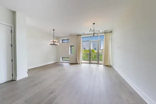 a view of a kitchen with a sink and a refrigerator