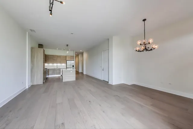 a kitchen with stainless steel appliances granite countertop a stove a refrigerator and a refrigerator