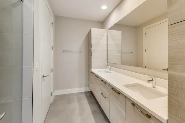 a view of staircase with lots of frames on wall and windows