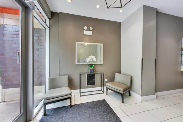 a view of a room with wooden floor a ceiling fan and window